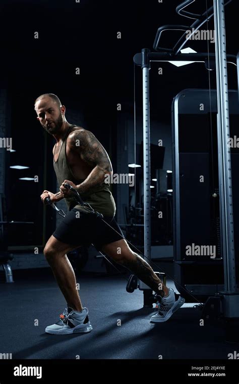 Portrait Of Muscular Bodybuilder Doing Low Cable Crossover Exercise