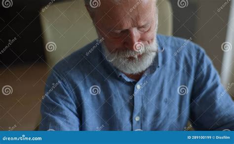 Closeup Face Of Sick Bearded Mature Man Working On Laptop And Coughing