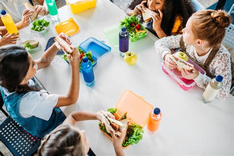 High Angle View Of Group Of Schoolgirls Taking Lunch At School