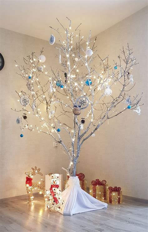 A Christmas Tree With Presents Under It And Lights On The Branches In