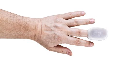 Premium Photo | Pulse oximeter on male finger tip isolated