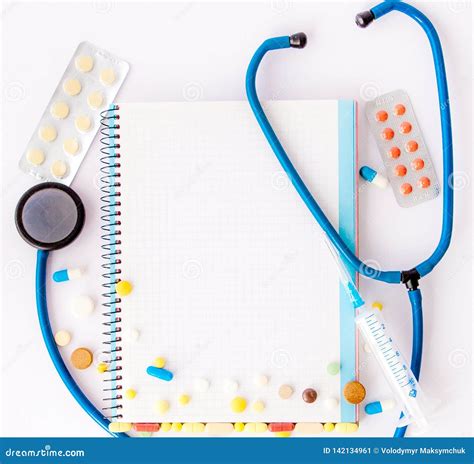 Workplace Of Doctor Stethoscope Notebook Medical Items And Pills On