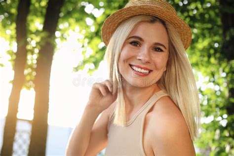 Portrait Of Beautiful Woman In Straw Hat Outdoors On Sunny Day Stock