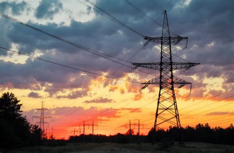 Silhouette High Voltage Electric Towers At Sunset Time High Voltage