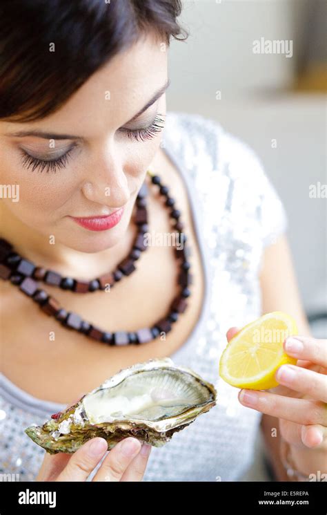 Woman eating oyster Stock Photo - Alamy