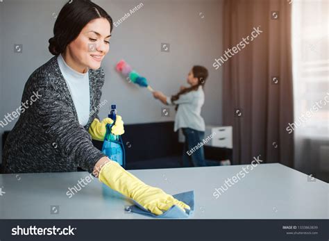 Beautiful Brunette Caucasian Mother Daughter Cleaning Stock Photo
