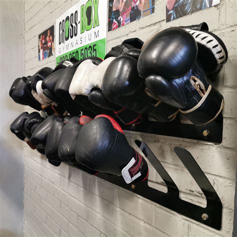 A Row Of Boxing Gloves Hanging On A Wall