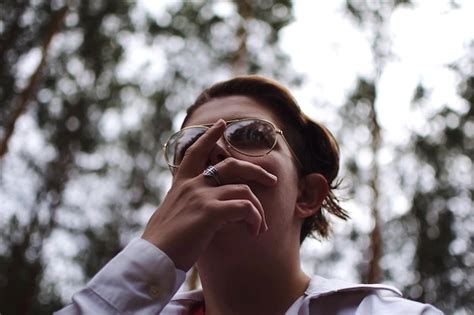 Premium Photo Low Angle View Of Woman Wearing Sunglasses In Forest