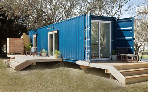 A Blue Shipping Container Sitting On Top Of A Wooden Deck