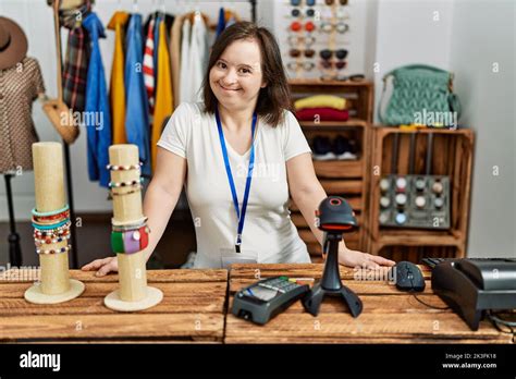 Brunette Woman With Down Syndrome Smiling Working As Shop Assistant At