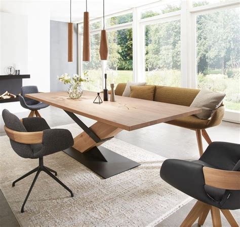 The Modern Dining Table Is Made From Wood And Has Two Chairs Around It