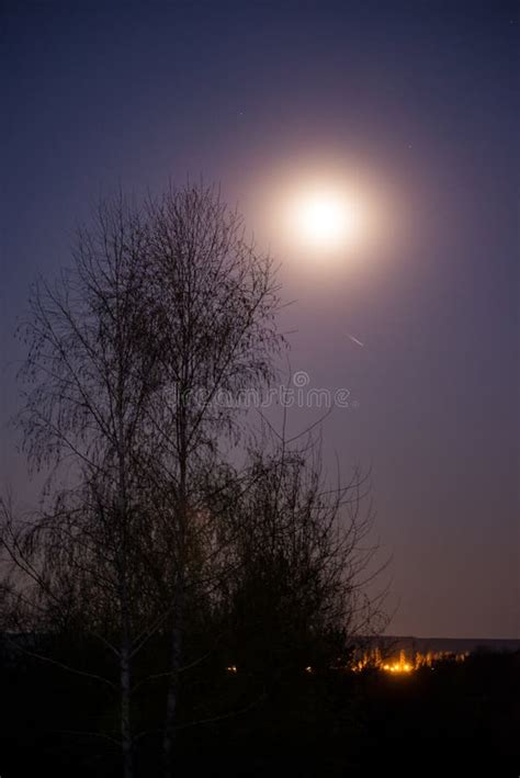 The Full Moon Shining Brightly In The Night Sky Above The Artificial