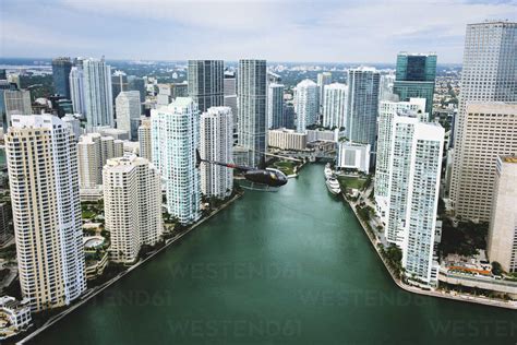 Skyscrapers and helicopter above Miami River, Brickell, Downtown Miami ...