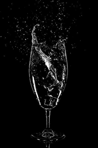 Premium Photo Water Splash In A Glass On A Black Background