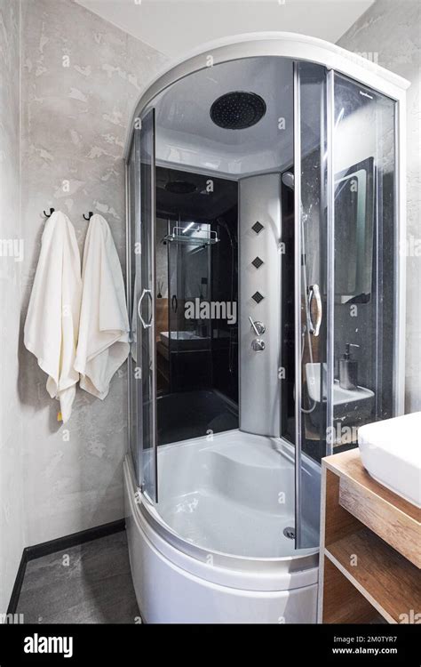 Small Gray Tile Bathroom With Fully Equipped Shower Cabin And Ceramic