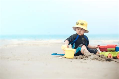 Premium Photo Cute Baby Boy Playing With Beach Toys On Tropical Beach