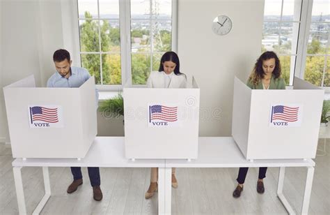 American Citizens Standing At Vote Center In Voting Booth At Polling