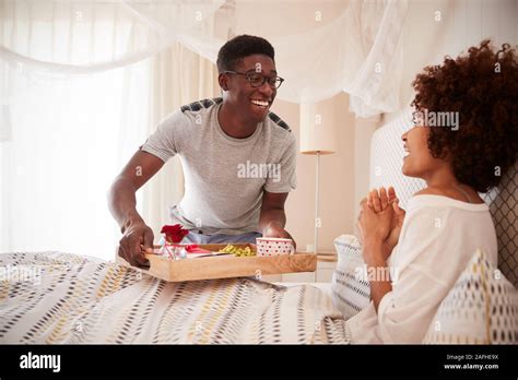 Millennial African American Couple Celebrating Man Bringing His