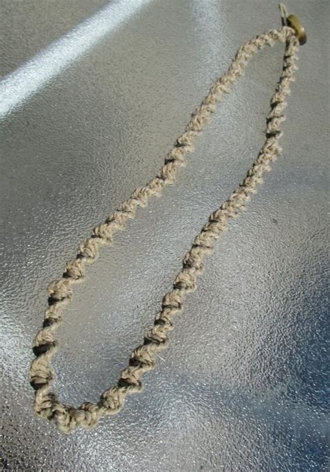 A Necklace Is Laying On The Ground With A String Attached To It S End