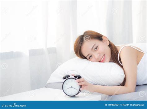 Beautiful Asian Young Woman Turn Off Alarm Clock In Morning Wake Up