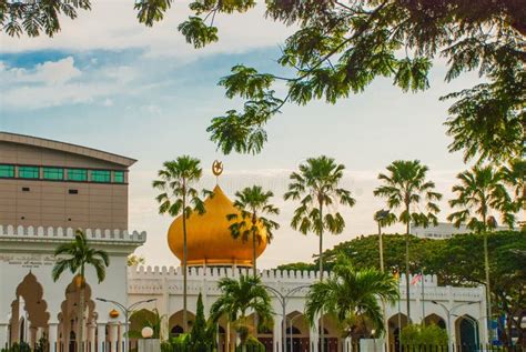 Masjid At Taqwa Mosque With Its Golden Dome And Palm Trees Miri City