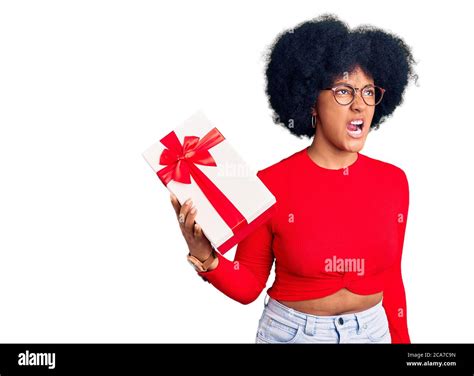 Young African American Girl Holding T Angry And Mad Screaming Frustrated And Furious