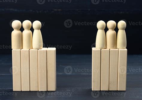 groups of wooden figures of men stand opposite each other. Conflict of