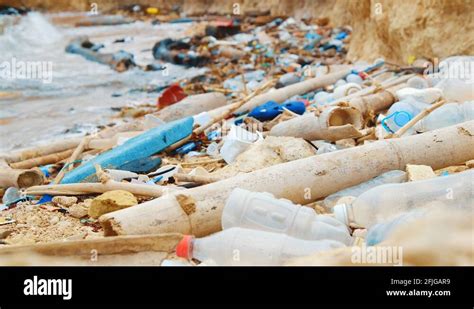 Plastic Bottles And Rubbish Debris Littered Across Beach Racking Focus