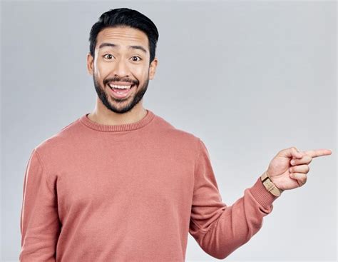 Premium Photo Excited Gesture And Portrait Of Indian Man Pointing At