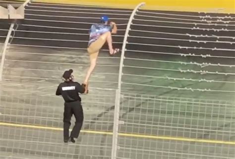 NASCAR Fan Climbs The Fence During The Race At Charlotte Motor Speedway