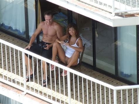 In A Short Dress And Showing Her Pussy From Hotel Balcony