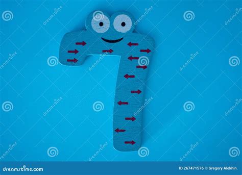 Cute And Colorful Wooden Number 7 With Eyes On A Blue Background Stock