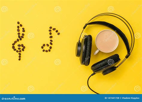 Notes Of Coffee Beans Headphones And A Cup Of Coffee On A Yellow