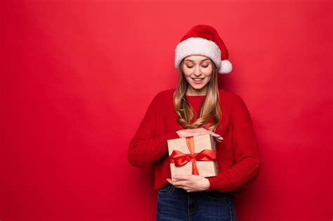 Linda mulher chapéu de papai noel segurando uma caixa de presente