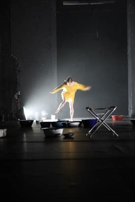 A Person Standing On Top Of A Chair In The Dark