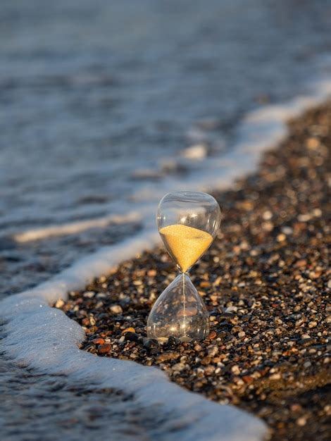 Premium Photo Hourglass On The Beach At The Seashore