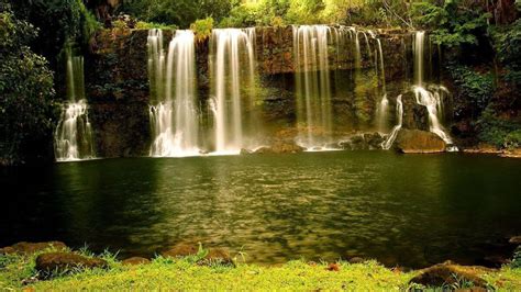 Landscape View Of Beautiful Waterfalls Pouring On River Surrounded By