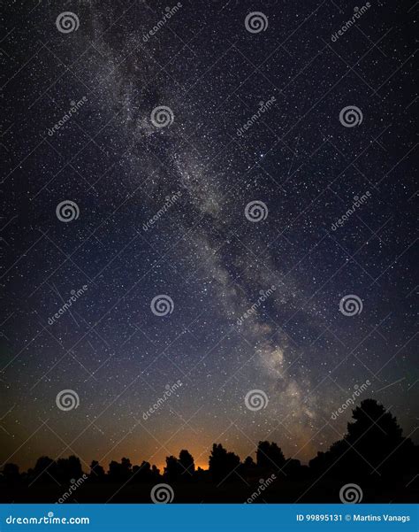 Colorful Milky Way Galaxy Seen In Night Sky Over Trees Stock Image