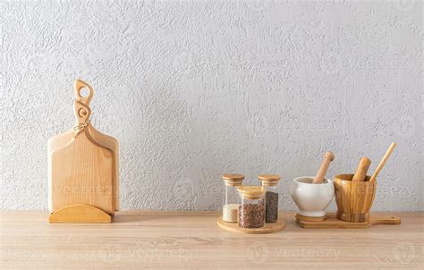 A set of glass spice jars, two mortars with a pestle, cutting wooden