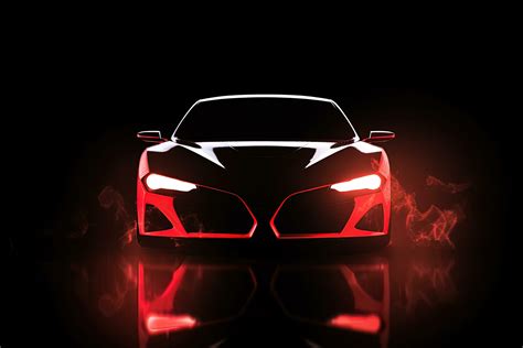 Front view dark silhouette of a modern sport red car isolated on dark ...