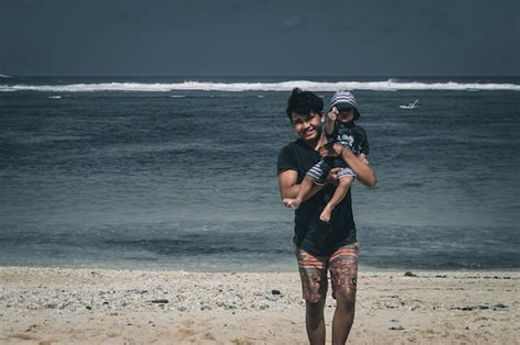 Premium Photo Father And Son Play On The Beach