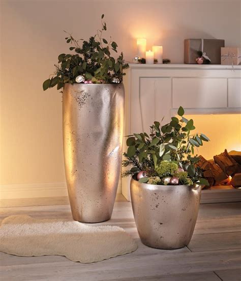 Two Large Metal Planters Sitting On Top Of A Wooden Floor Next To A