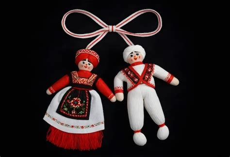 Premium Photo | Two martenitsa dolls in traditional costumes hanging ...