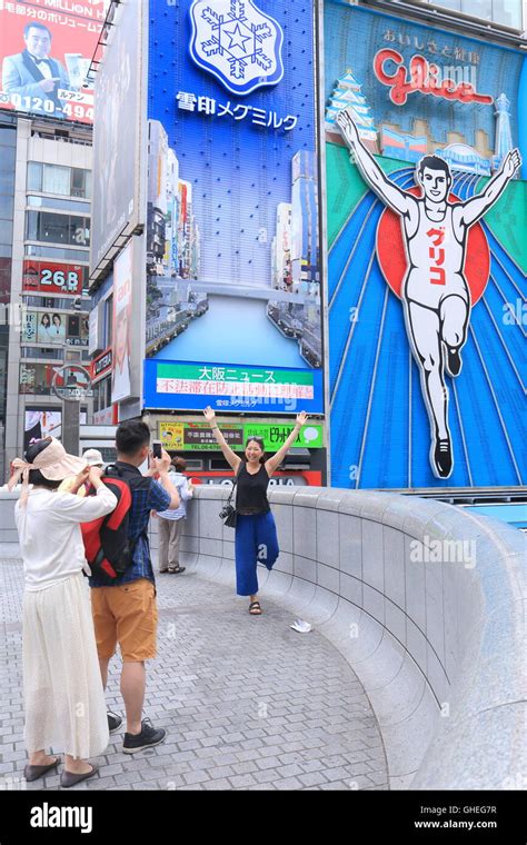 People pose in front of Glico Man sign in Dotonbori in Osaka Japan ...