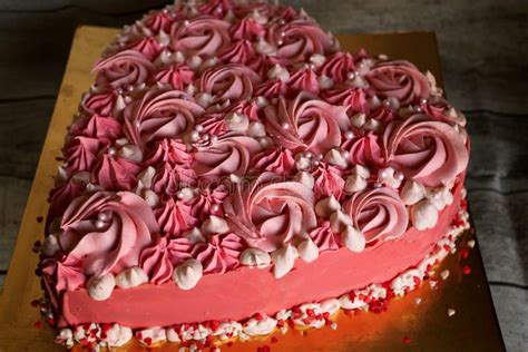 Pink Heart Shaped Cake Decorated With Cream In The Form Of Curls And