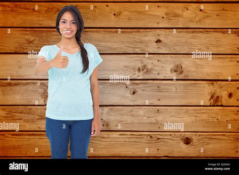Composite Image Of Happy Brunette Giving Thumbs Up Stock Photo Alamy