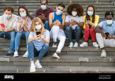 Young Multiracial Group Of Friends Using Mobile Smartphone While