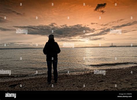 Silhouette Of Woman Watching The Sunset Hi Res Stock Photography And