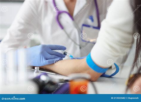 Doctor Gives An Intravenous Injection To Patient In Medical Office