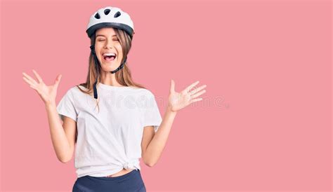 Young Beautiful Girl Wearing Bike Helmet Celebrating Mad And Crazy For